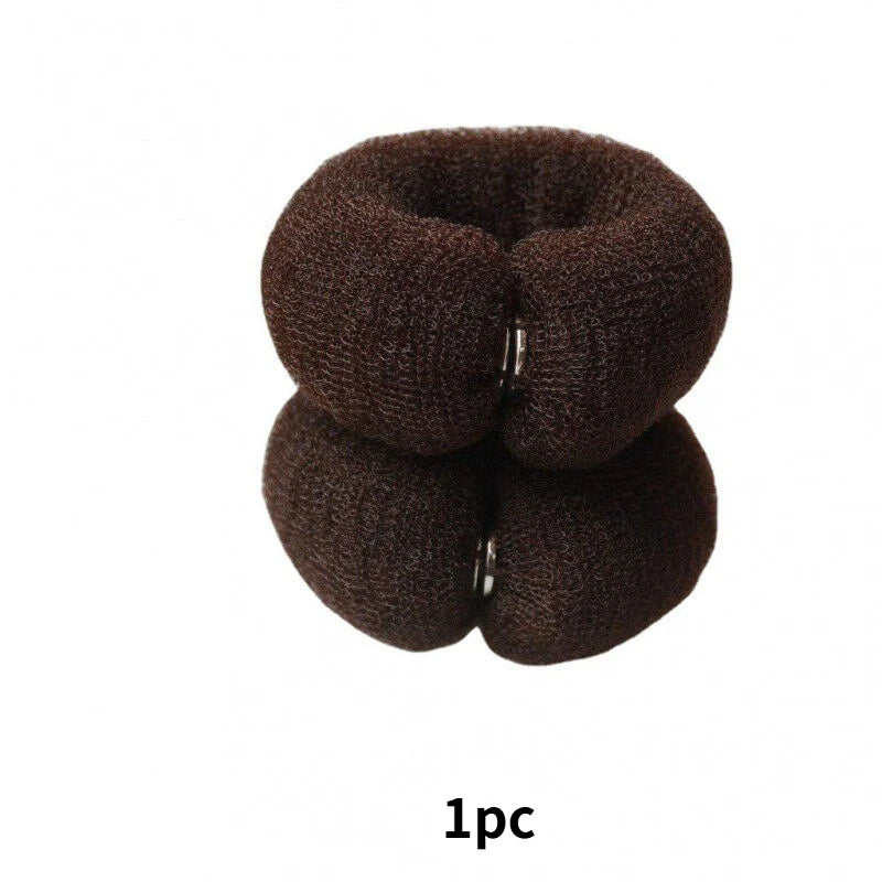 A pair of dark brown, elastic gauze tools used for creating hair buns.