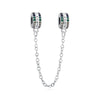 A silver chain necklace featuring a family tree charm pendant with green and clear stones.