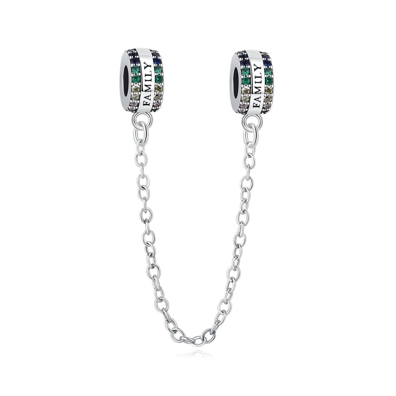 A silver chain necklace featuring a family tree charm pendant with green and clear stones.