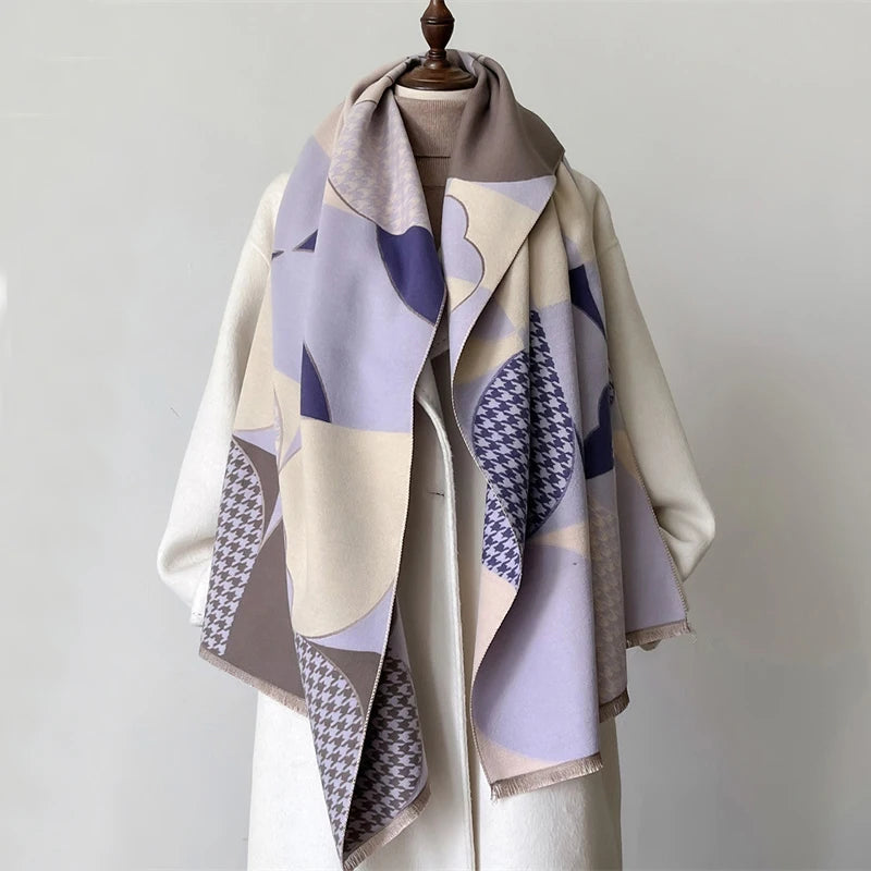 A beige and purple plaid cashmere scarf draped over a light colored coat.
