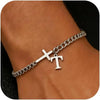 A close-up of a personalized stainless steel cross Cuban chain bracelet worn on a wrist.