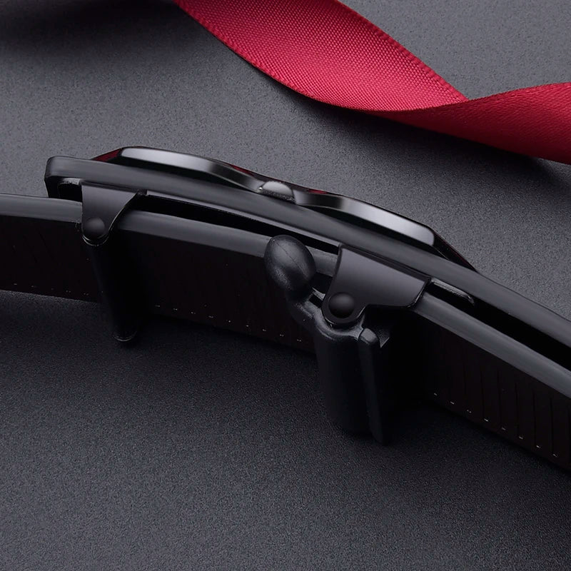 A close-up of a black leather belt with a buckle and a red ribbon, shown against a dark background.