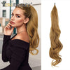 A model shows off long, blonde hair extensions being styled in a ponytail.