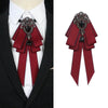 A deep red velvet bow tie with intricate silver rhinestone detailing worn on a white shirt.