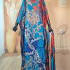 An elegant printed silk kaftan dress in blue and orange floral patterns displayed on a mannequin.