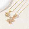 Gold initial letter necklace set featuring CZ crystal pendants for a couple