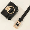 A black PU leather belt bag with a gold-toned metal buckle and strap is shown against a white background.
