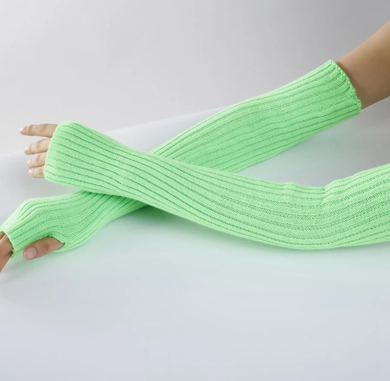 A hand wearing a light green knitted fingerless glove on the forearm.