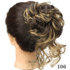 A dark brown messy synthetic hairpiece bun styled in loose waves
