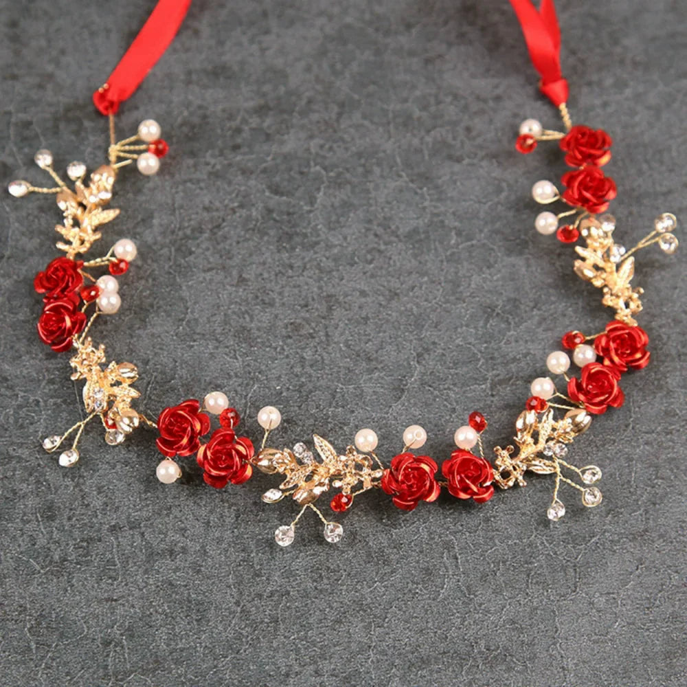 A red rose pearl crystal headband with gold accents and a red ribbon.