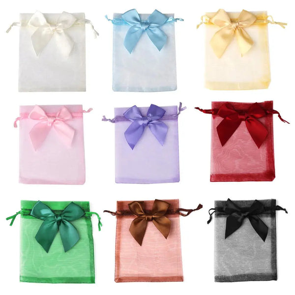 A collection of elegant organza drawstring gift bags in various pastel and jewel tones like blue, pink, purple, and gold.