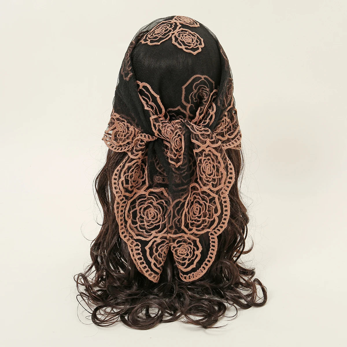 A dark brown floral embroidered lace bandana headscarf with long, wavy hair.