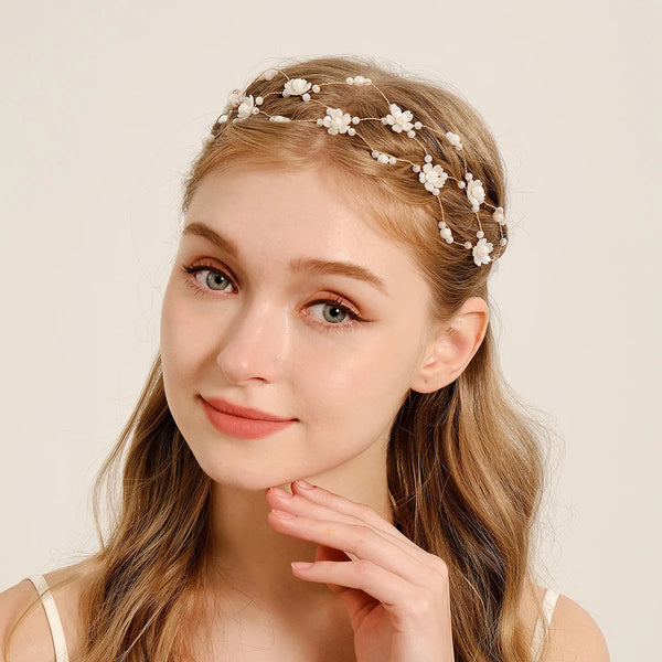A young woman with long blonde hair wears an elegant pearl hair net headband.