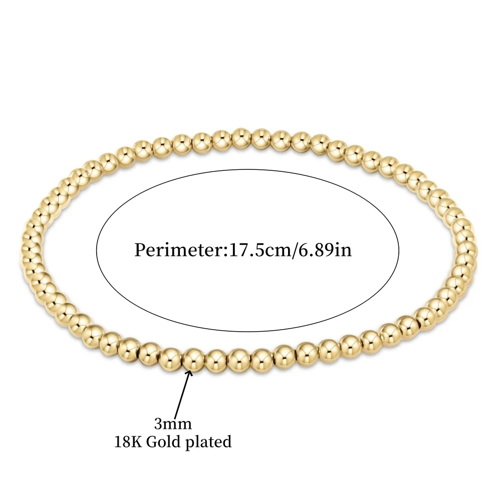 Une rangée de perles de nacre dorées plaquées formant un bracelet circulaire de 17,5 cm de périmètre.
