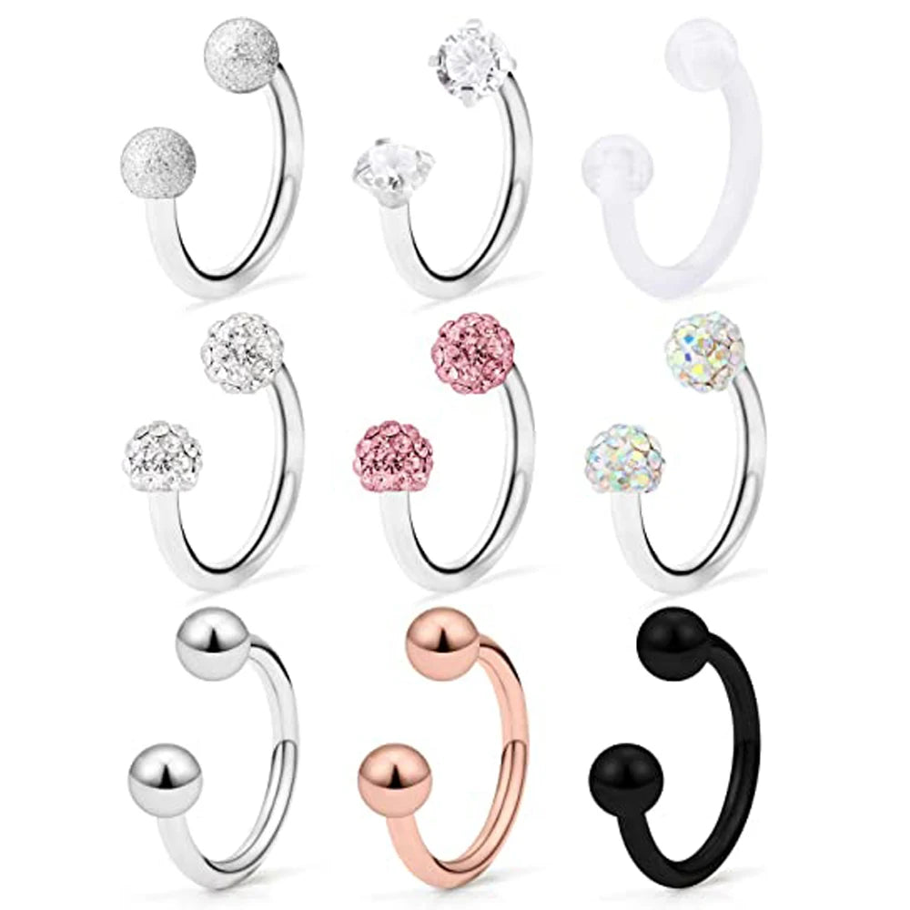 A set of crystal horseshoe barbell rings in various sizes and finishes including silver, rose gold, and black.