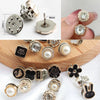 A collection of elegant button brooch pins featuring various designs including floral shapes, animals, and pearl accents.