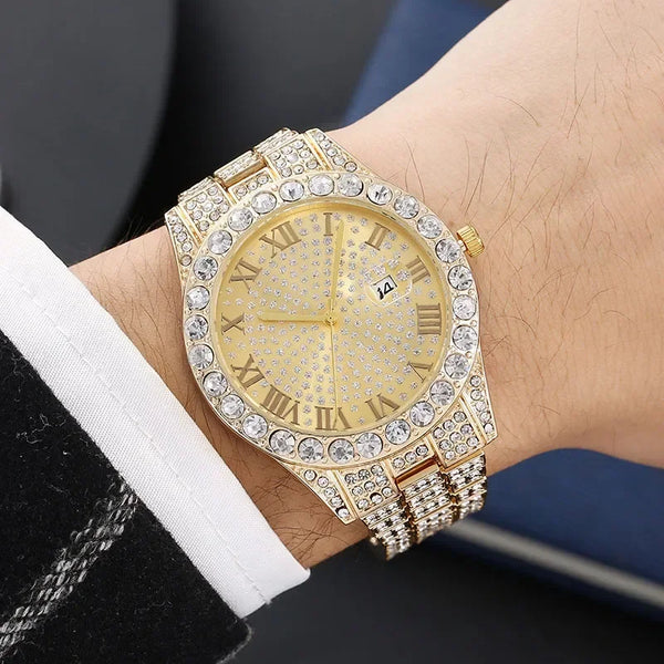 A gold-toned wristwatch with a diamond-encrusted bezel and bracelet worn on a wrist.