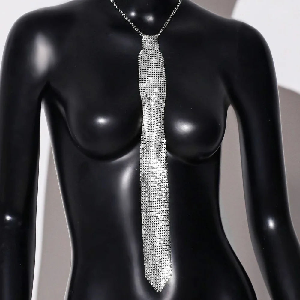 A silver crystal rhinestone sequin neck tie necklace displayed on a black mannequin.