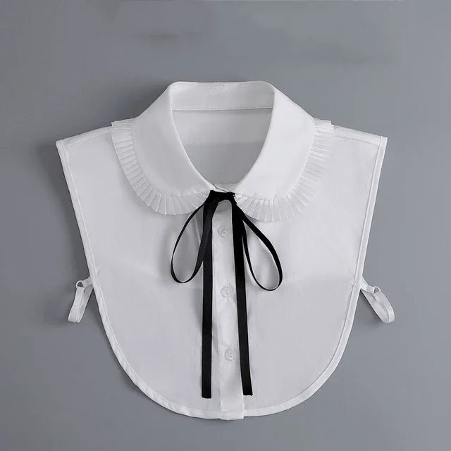 White blouse with a false collar and black tie detail