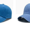 A pair of denim blue baseball caps shown in two views, one showing the front and another showing the side.