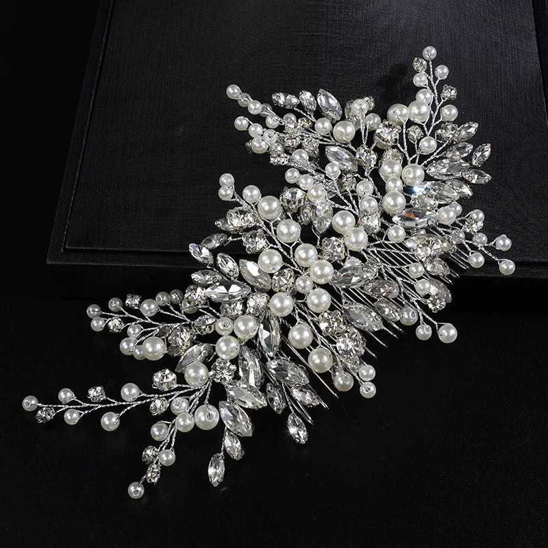 A delicate bridal headpiece featuring white pearls and clear rhinestones arranged in a floral spray.