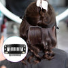 A close-up of dark hair styled in a bun with snap clips, showing the hair extension product.