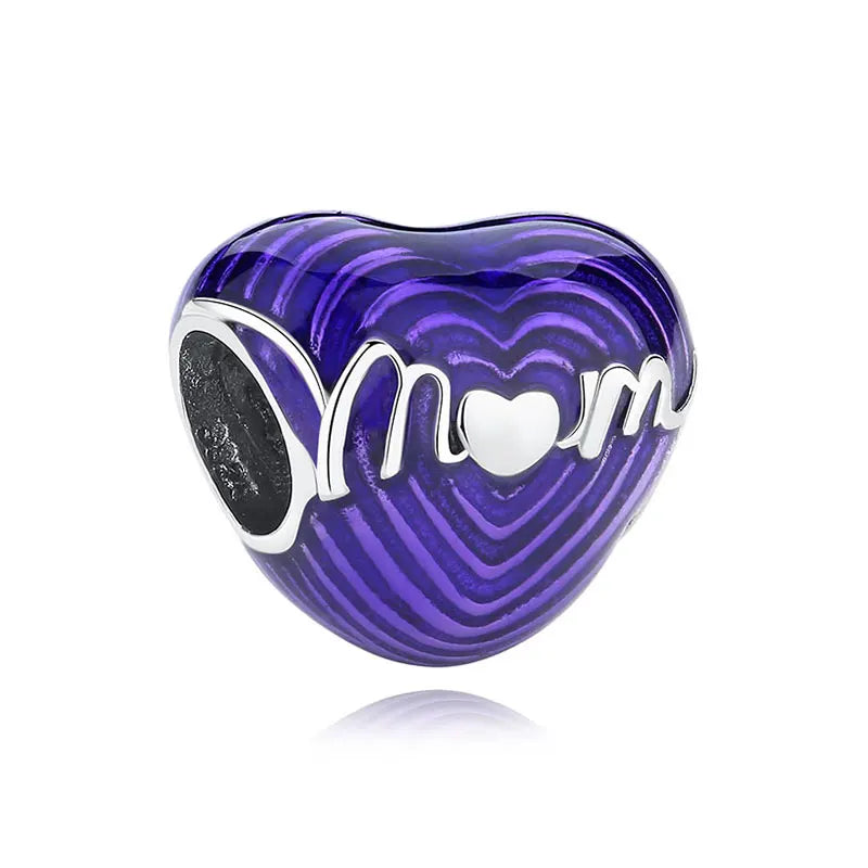 A heart-shaped charm made of purple iridescent glass with a silver embossed mother monogram.
