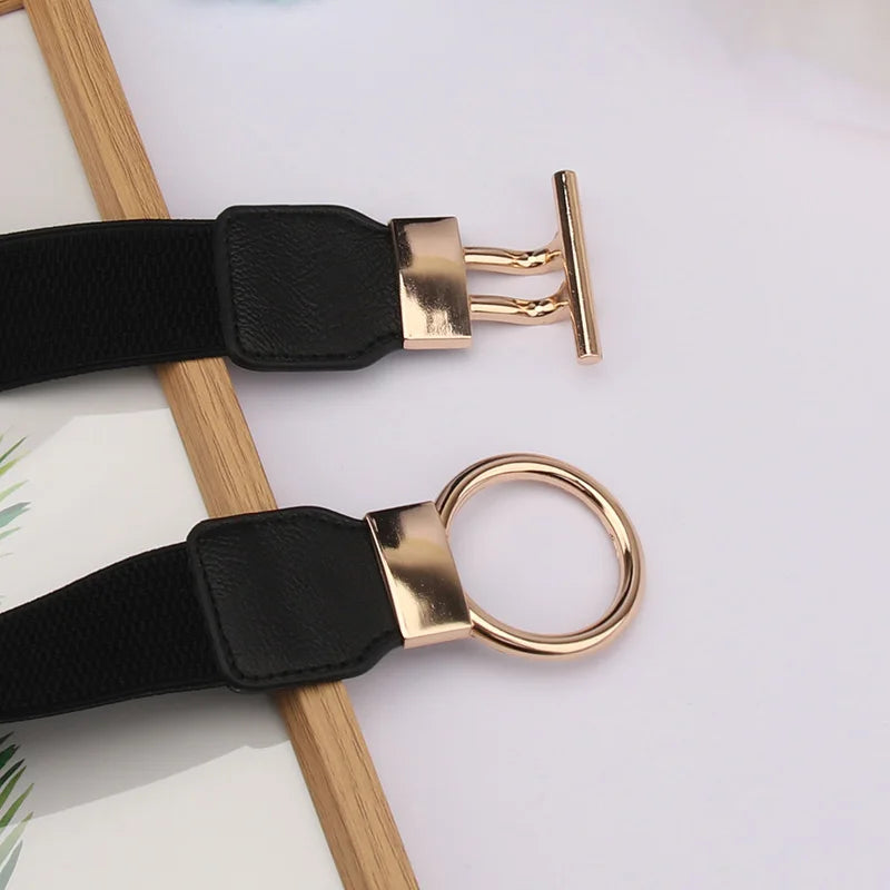 A black adjustable fashion round buckle belt with a gold-tone buckle and leather strap.