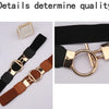 A close-up of a black and gold adjustable fashion round buckle belt with brown leather accents.