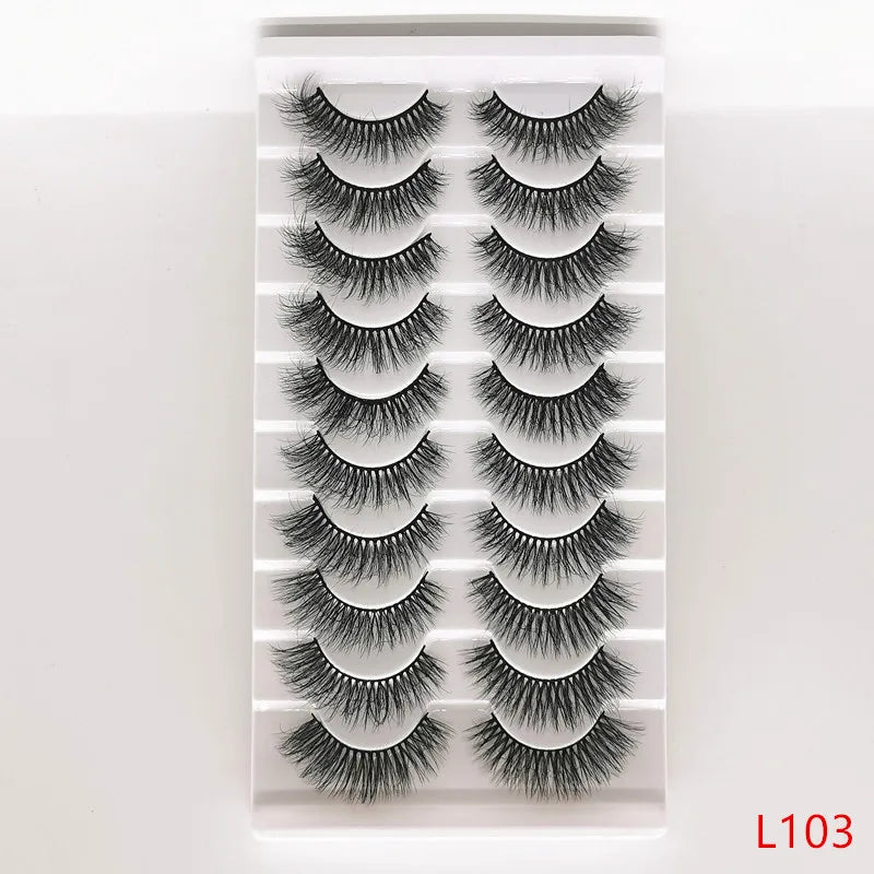 A strip of dramatic mink false eyelashes displayed in a clear plastic container.