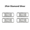 A pair of diamond silver shoe charms and laces.