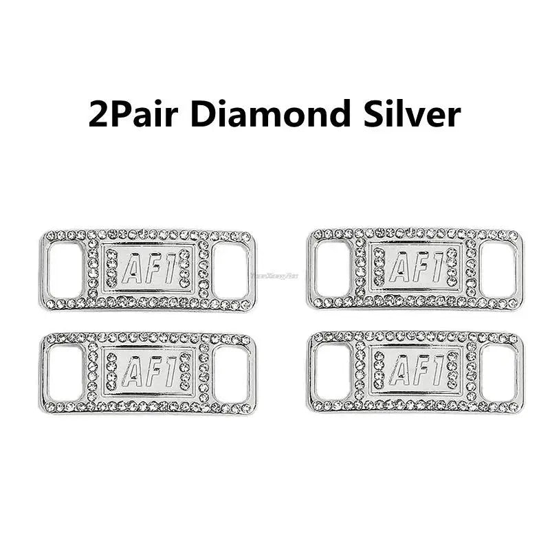 A pair of diamond silver shoe charms and laces.