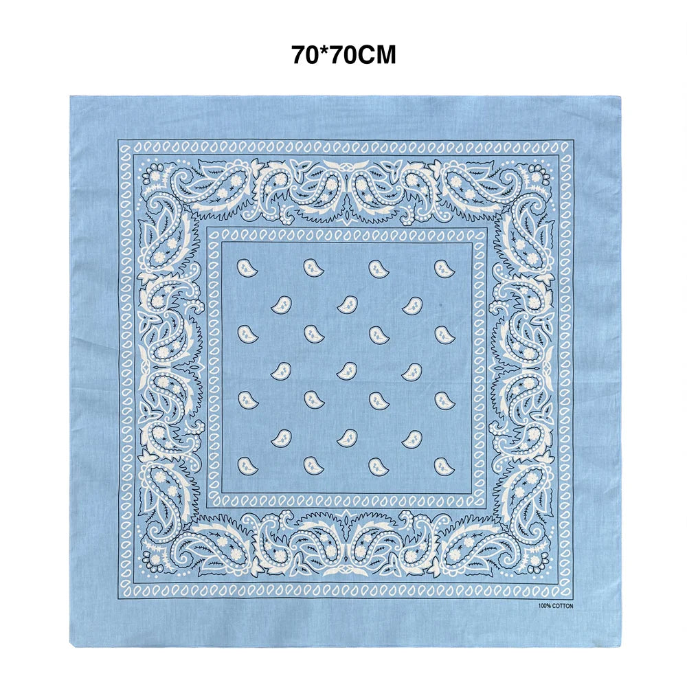 Light blue cotton bandana scarf featuring intricate white paisley embroidery on a square fabric.