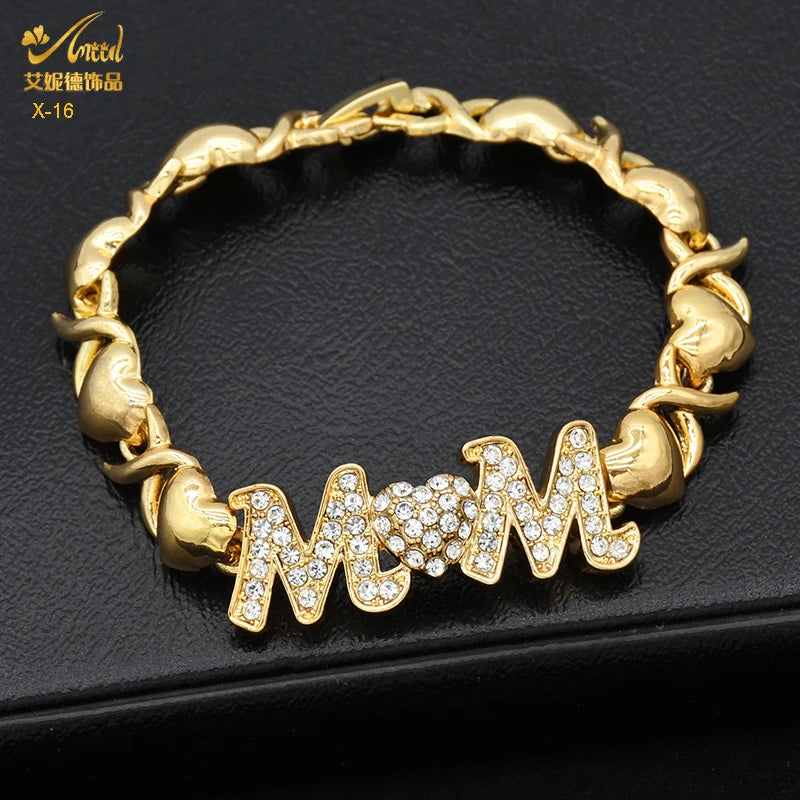 A gold heart crystal jewelry set spelling out MOM on a bracelet