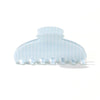 A clear plastic hair clips set with a light blue striped pattern.