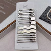 A set of vintage silver Y2K metal hair clips displayed on a white card against a neutral background.