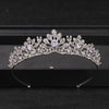 A sparkling crystal rhinestone bridal tiara headpiece displayed on a dark surface.