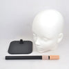 A white professional mannequin head with a black stand and a wooden brush attached.