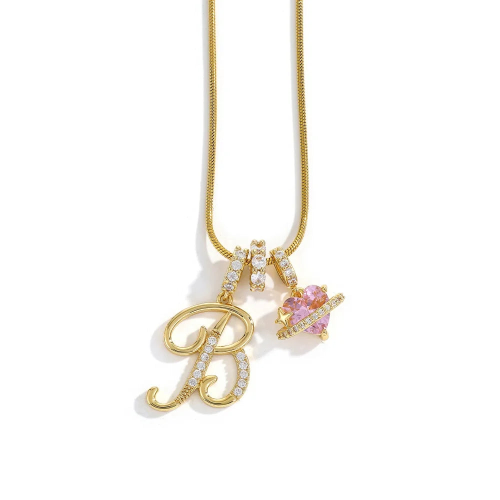 A gold chain necklace featuring an initial pendant shaped like the letter B and a pink flower charm.
