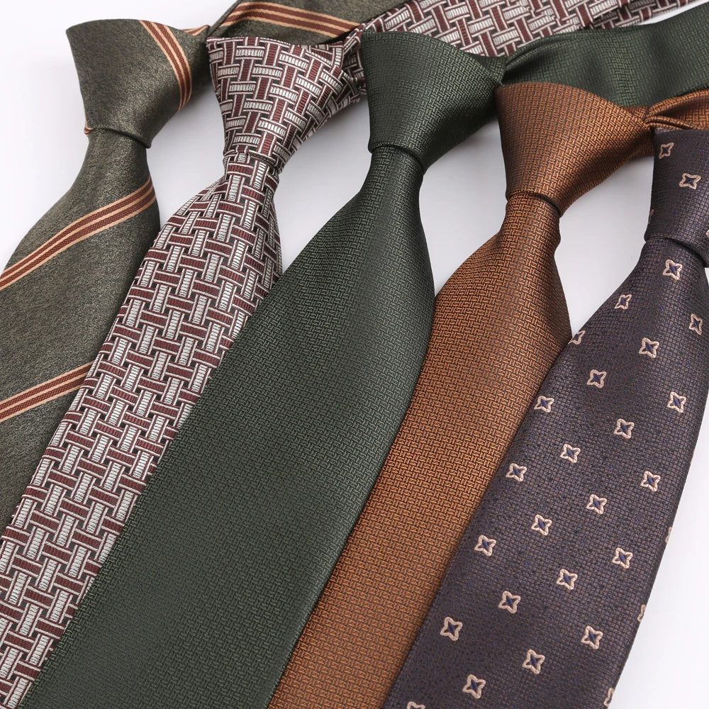 Eine Sammlung von Herren-Einstecktuchchen aus festem Twill mit Streifen in verschiedenen Grüntönen, Brauntönen und Grautönen.