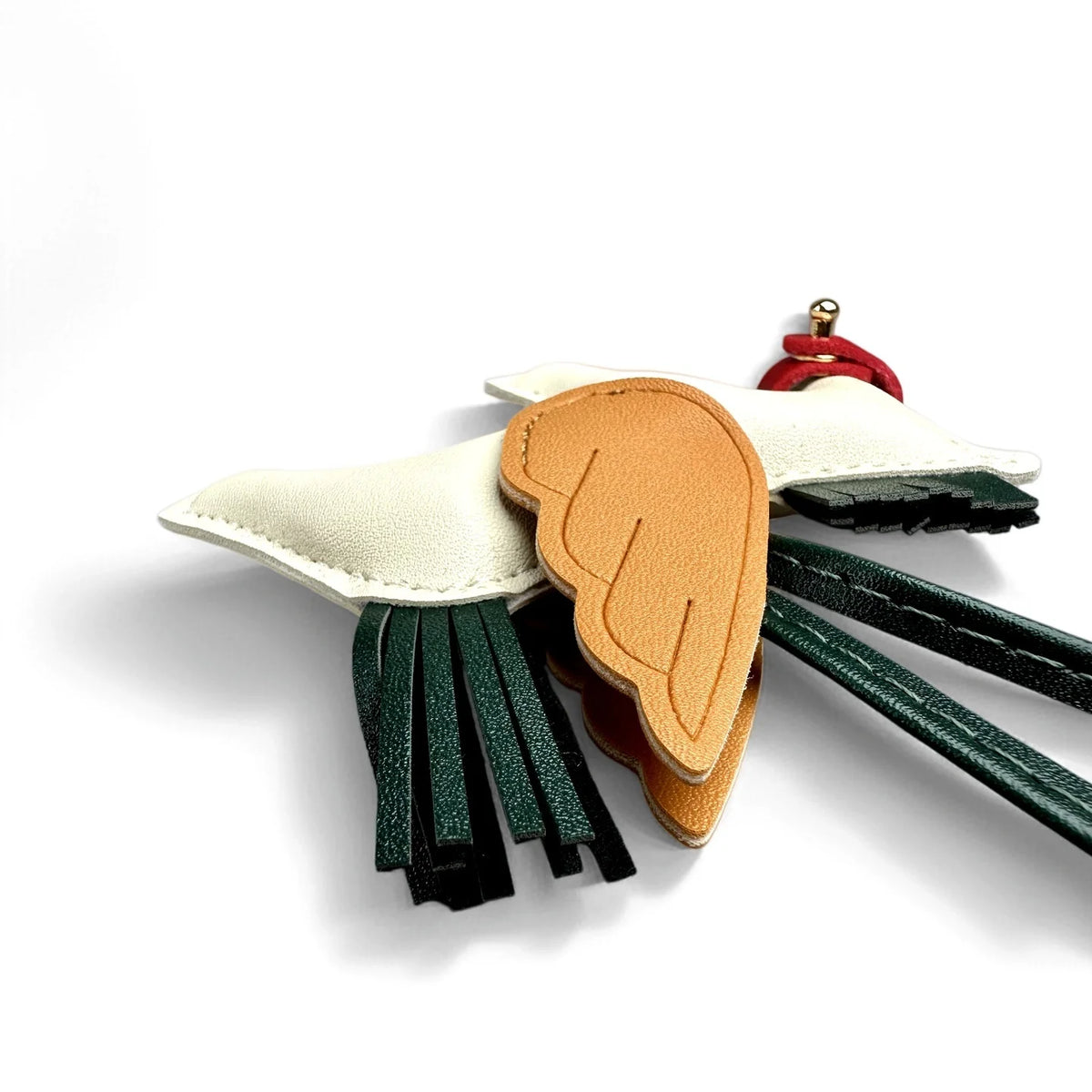 An elegant winged pony keychain featuring white and orange feather shapes with dark green tassels.