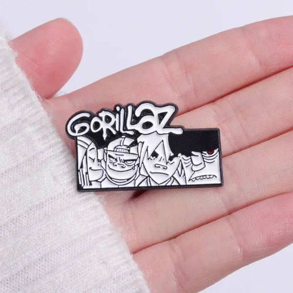 A black enamel pin featuring a stylized graphic of a gorilla face and text.