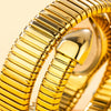 A close-up of a gold quartz snake design ladies watch band showing the textured metal links.