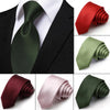 A collection of men's satin neck ties in various shades of green, red, and pink displayed on a black suit jacket.