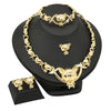 A set of 18K gold heart crystal jewelry including a necklace and earrings displayed on a black stand.