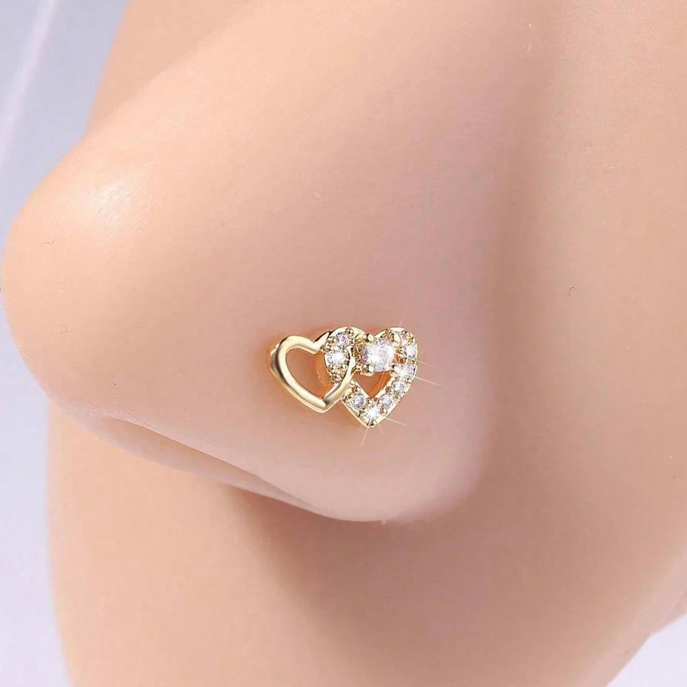 Gold-toned stainless steel heart horseshoe nose studs with small diamonds
