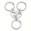Silver keychain set featuring puzzle heart charms labeled Mom, Big sister, and Little sister
