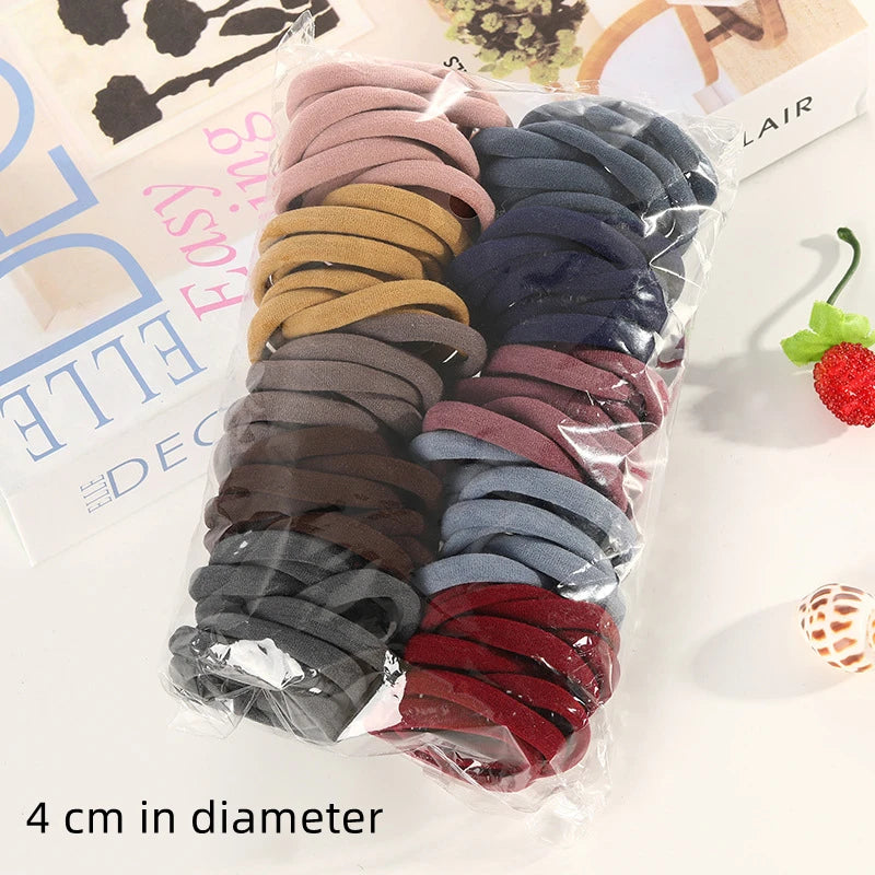 A collection of 100 high elasticity hair ropes in various shades of brown, gray, and burgundy packaged in a clear plastic bag