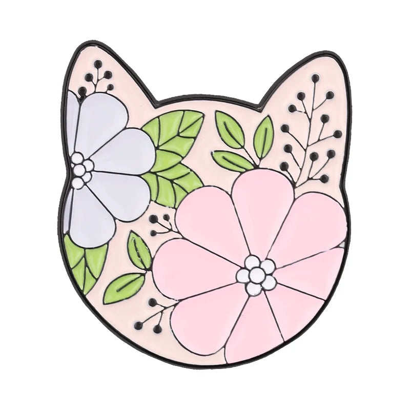 A pink and white enamel flower brooch featuring a detailed floral design.