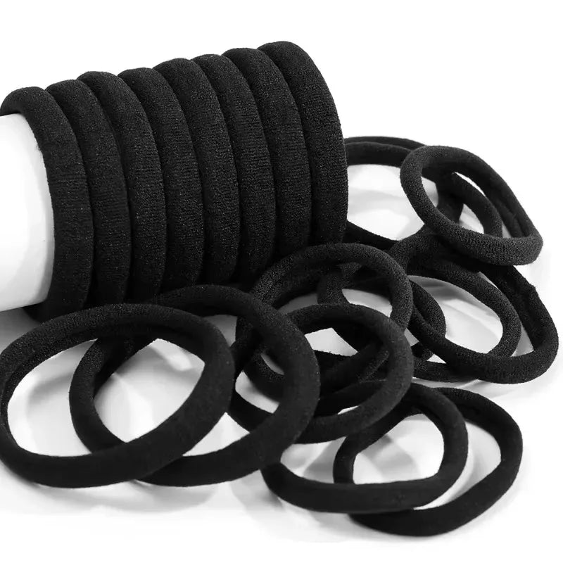 A stack of black elastic hair bands coiled together.